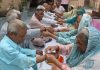 Women tying Rakhis around the wrists of male inmates in Old Age Home, Jammu on Wednesday. -Excelsior/Rakesh