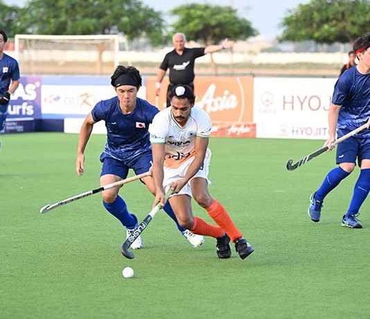 Players in action during a match between India and Japan.