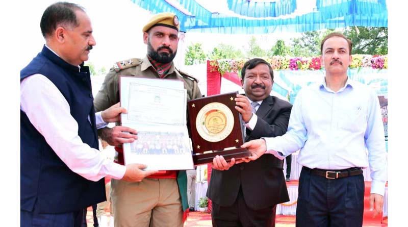 Dheeraj Gupta presenting best performing awards to trainees during Passing out Parade of Forest Department on Friday.