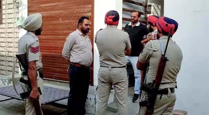Police personnel stand guard as NIA conducts raid in connection with the terror-narcotics-smuggler-gangster nexus cases in Bathinda area of Punjab on Wednesday.