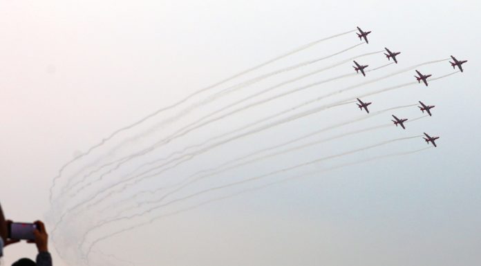 People try to capture a view of air show in Jammu on Friday. - Excelsior/Rakesh