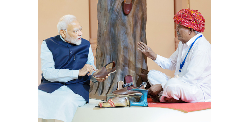 PM Narendra Modi meets a worker during launch of Vishwakarma Scheme at Dwarka, New Delhi on Sunday.