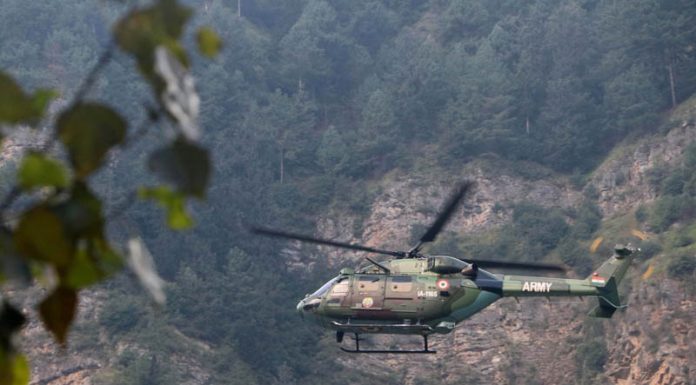 An Army helicopter keeping surveillance during the ongoing encounter at Godool forests in Kokernag area of Anantnag on Friday.