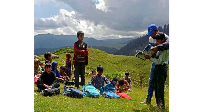 Bakerwal children attending a Season School, locally known as Bohaks, in the high altitude area of Tosa Maidan of Budgam district, some 75 kms from Srinagar on Monday. (UNI)