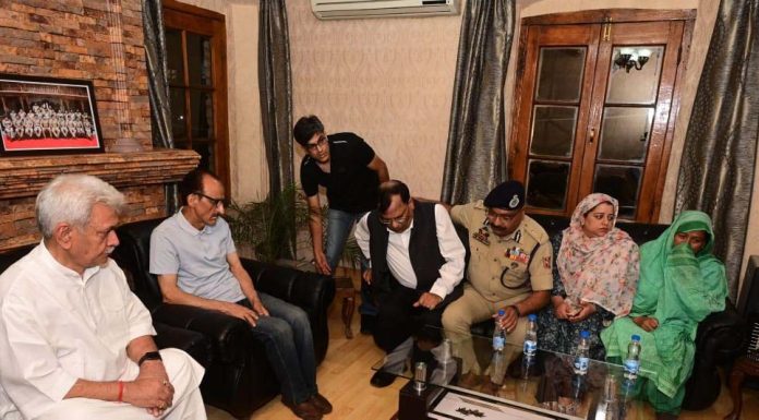 LG Manoj Sinha with family members of martyr DySP Humayun Bhat at their residence in Srinagar.