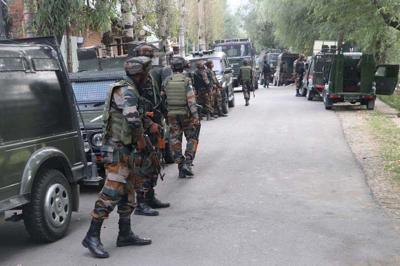 Security forces walk towards the encounter site in Gadole Kokernag area of Anantnag district on Wednesday.