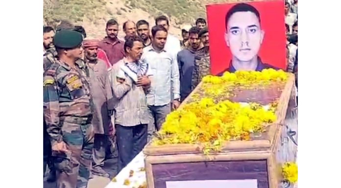 Relatives and locals pay respects to mortal remains of martyr Ravi Kumar Rana at Kishtwar on Thursday. - Excelsior/Tilak Raj