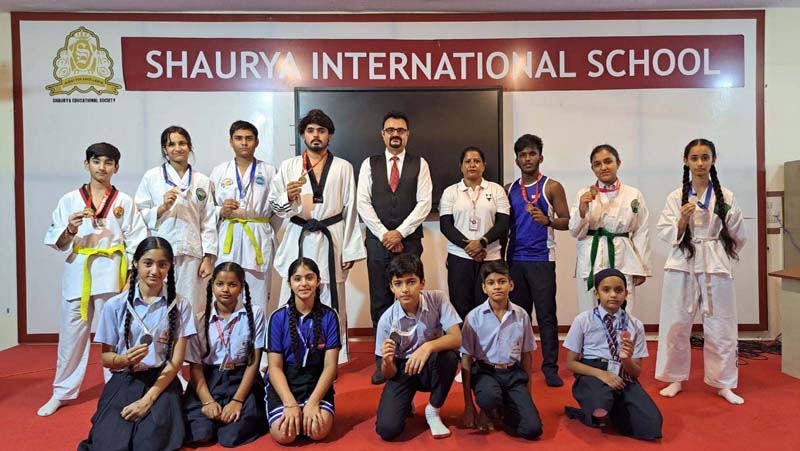 Students (Taekwondo players) of Shaurya International School posing with Principal on Monday.