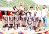 Winning Volleyball team posing with trophy at Poonch.