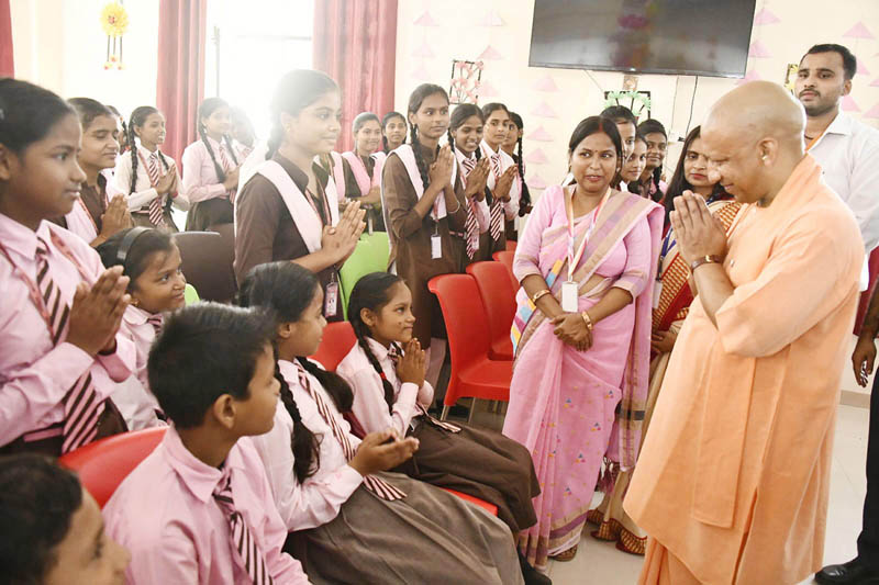 Uttar Pradesh Chief Minister Yogi Adityanath meeting with the students of government school 'Sanket' run by the Department of Empowerment of Persons with Disabilities, in Gorakhpur on Monday. (UNI)