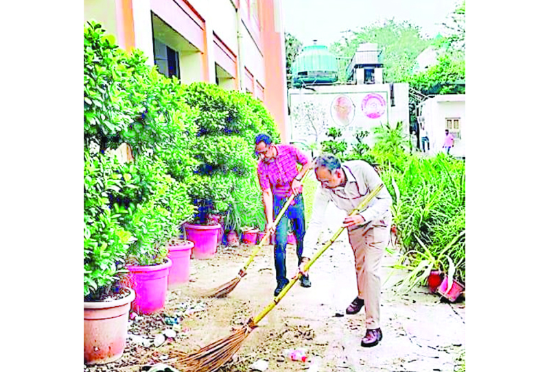 Officers and staff members participating in cleanliness drive at DRM Office, New Delhi on Saturday.