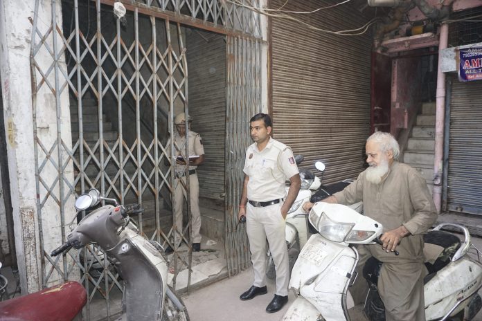 Police personnel stand guard as the National Investigation Agency (NIA) teams raid on the premises of the banned outfit Popular Front of India (PFI), in New Delhi
