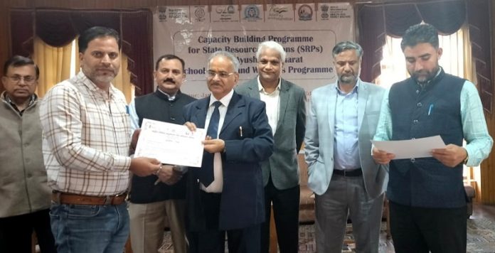 Chief guest presenting certificates to participants of NCERT capacity building programme at JKBOSE Campus.