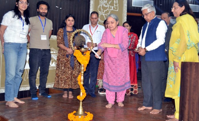 Guest lighting ceremonial lamp during inaugural of `Scientific & Technical Outreach Programme' by BARC at JU on Tuesday.