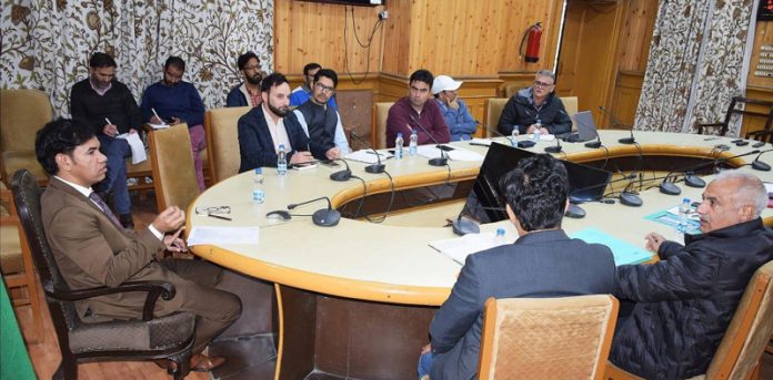 Div Com Kashmir chairing a meeting.