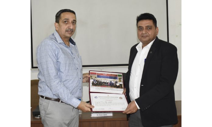 Deputy Director SKPA, Rajinder Kumar Gupta, presenting a certificate to a guest during a training program at SKPA Udhampur on Thursday.