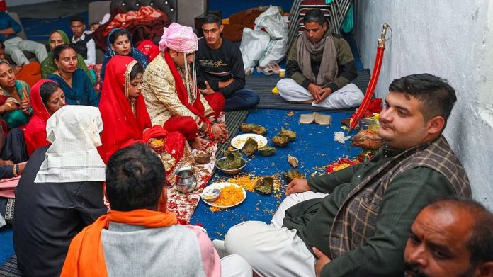 People during a marriage ceremony at a community centre, even as Pakistan Rangers fired without provocation along the international border in Arnia sector of Jammu & Kashmir.