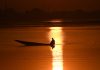 A picturesque sunset scene caught in the frame at Dal lake with a man seen rowing his boat on Monday. — Excelsior/Shakeel