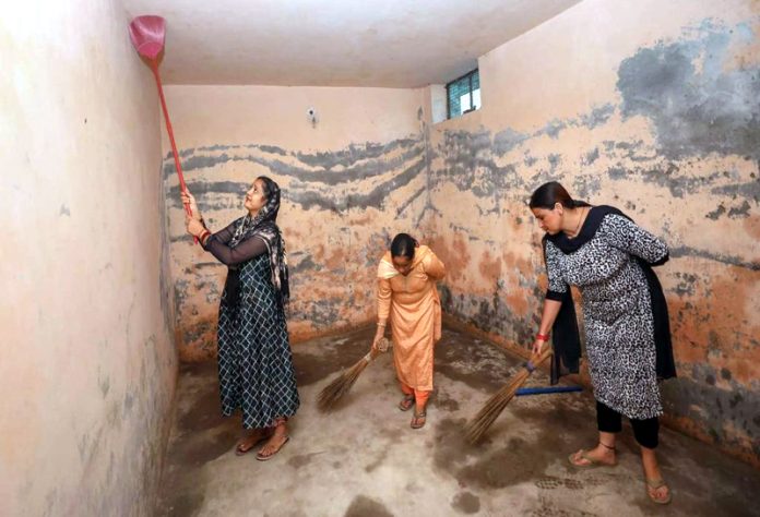 A group of women cleaning a safety bunker in Trewa Village on Sunday.