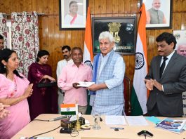LG Manoj Sinha handing over land allotment letter to a beneficiary in Srinagar on Monday.