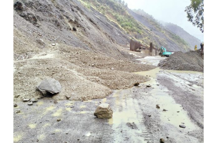 Jammu-Srinagar National Highway blocked due to landslides at Mehar Cafeteria stretch near Ramban on Tuesday. Another pic on page 17. —Excelsior/Parvez Mir