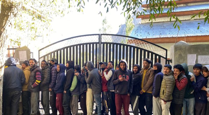 Voters in a queue outside a polling station in Kargil on Wednesday. Another pic on page 4. — Excelsior/Basharat Ladakhi