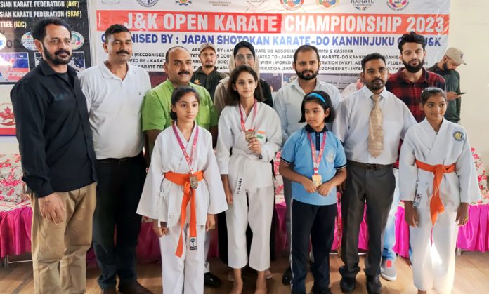 BJP leader Munish Sharma posing with the winners of J&K Open Karate Championship.