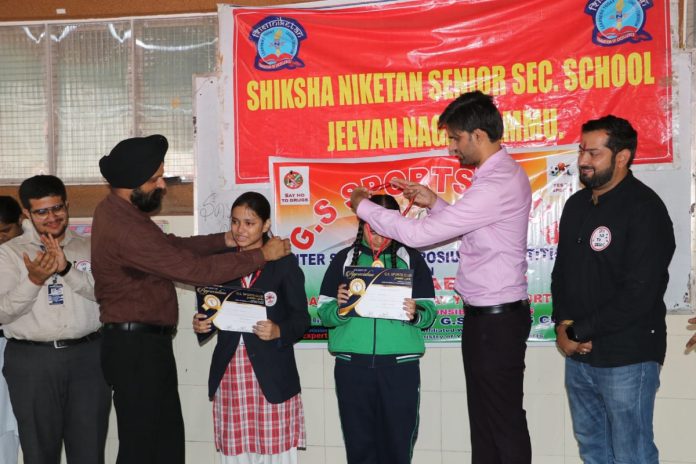 Winners being presented medals by dignitaries.