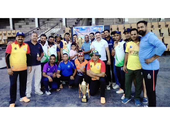 Players of Jammu Enterprises posing after winning the trophy.
