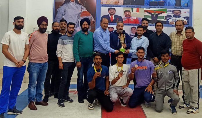 Fencers posing with medals and trophy at Jammu University on Wednesday.