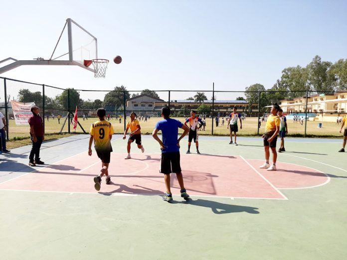 Basketball players in action during a match at Udhampur.