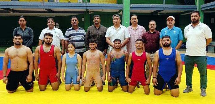 Wrestlers posing with dignitaries during selection trials at Jammu.