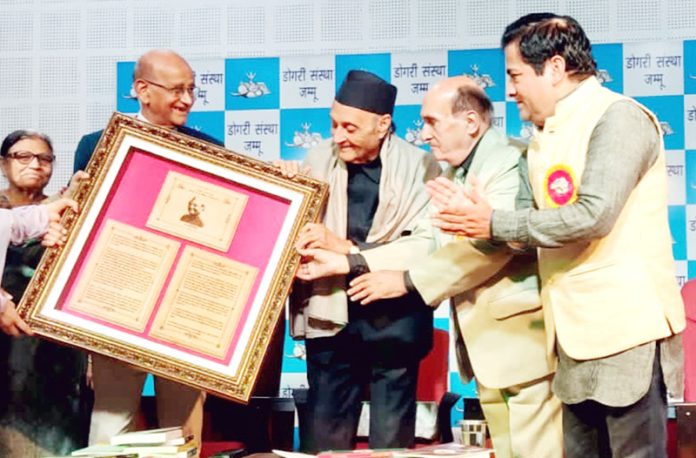 Members of Dogri Sanstha felicitating Dr Karan Singh during a special function at Jammu on Monday.