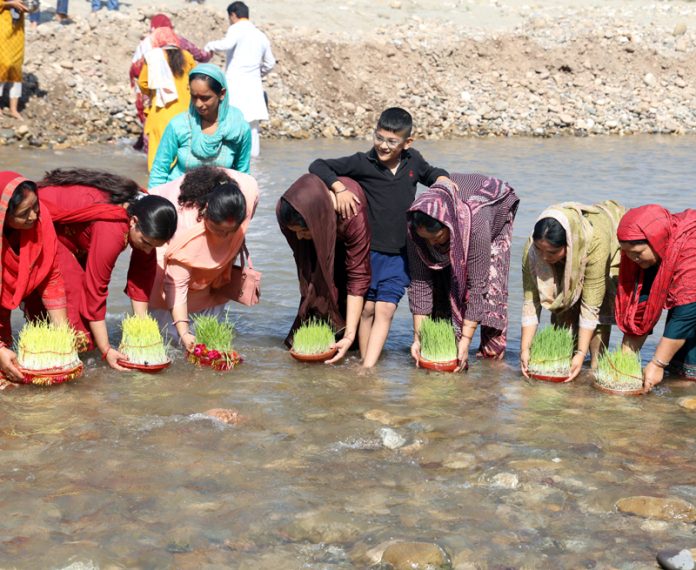 Devotees immersing Sakh in river Tawi on the occasion of Maha Navmi on Monday. Excelsior /Rakesh