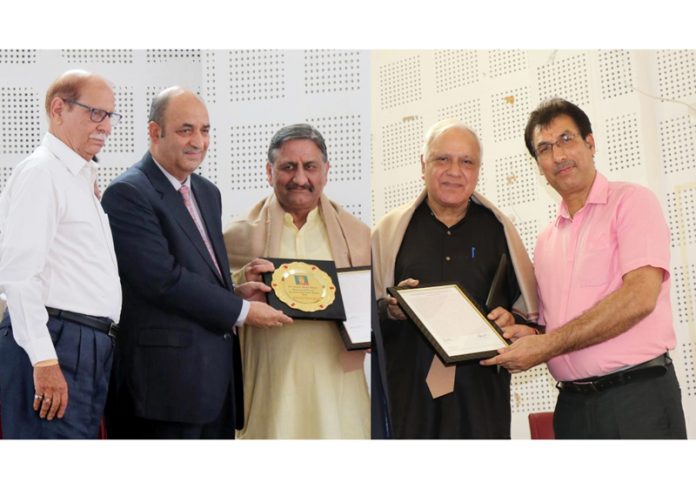 Justice (retd) BL Bhat and others presenting Amateur Journalist awards to Sqn Leader Anil Sehgal and Ashwani Kumar Chrungoo at Jammu on Wednesday.