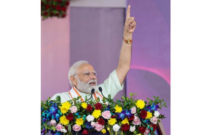 Prime Minister Narendra Modi addresses during an event organised for laying of foundation stone of various developmental projects, in Kheralu, Mehsana District, on Monday. (UNI)