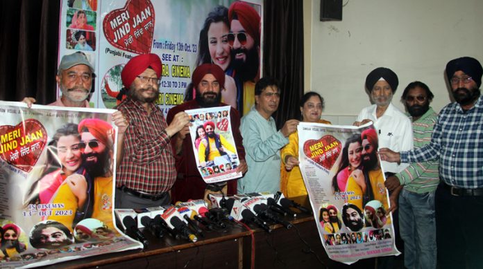 Production Head Shamsher Singh Chohalvi along with artists releasing poster of the J&K's Punjabi film 'Meri Jind Jaan' at Jammu. -Excelsior/Rakesh
