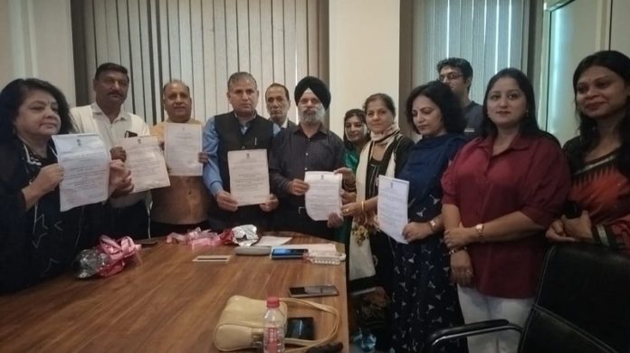 Delphic Council members displaying copy of a document during a meeting.