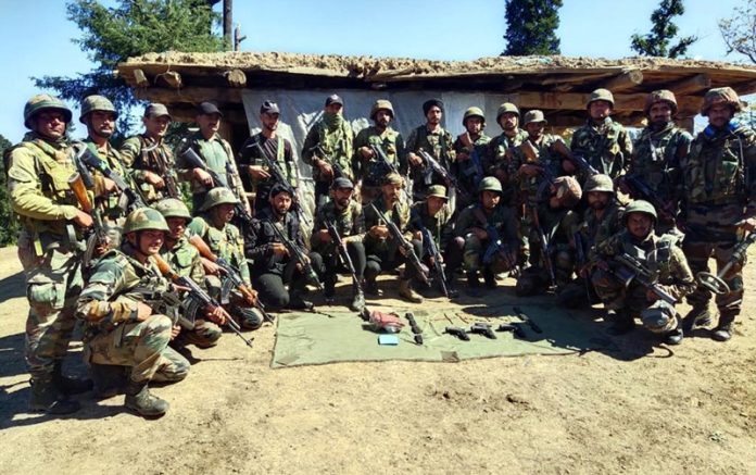 Search party with arms and ammunition recovered from a terrorist hideout in Seoj Dhar area of Doda District on Wednesday.