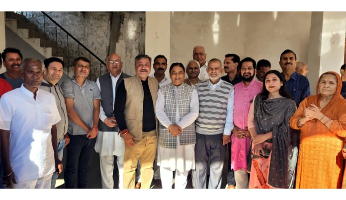 Senior BJP leader and former Minister, Sat Sharma and another party leader, Zorawar Singh Jamwal posing with residents of Shakti Nagar after kick starting development works on Saturday.