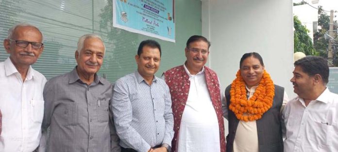 BJP leader Sat Sharma and others posing for a group photograph during a Kavi Goshthi.