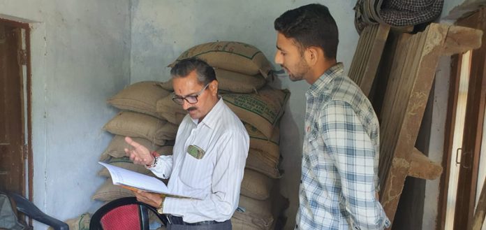 SDM Chowki Choura, Virender Gupta inspecting the record of a seed store on Friday.