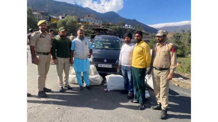 Drug peddlers with the seized poppy straw in Banihal on Wednesday.
