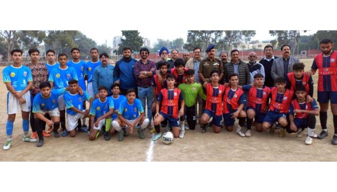 Football teams posing with dignitaries during a match on Saturday.