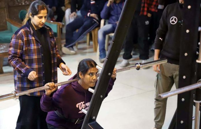 A Woman Powerlifter in action during a competition at NIT Srinagar.