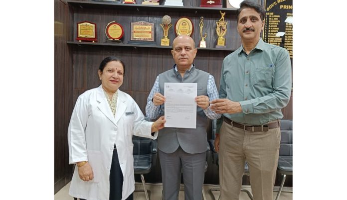 Principal and Dean, GMC Jammu, Dr Ashutosh Gupta showing certificate received by the hospital for being a registered Medical Centre for Palliative Care.