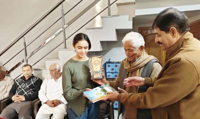 SVLARC officials presenting notebooks to a poor student during an awareness camp held at Rathian in district Udhampur.