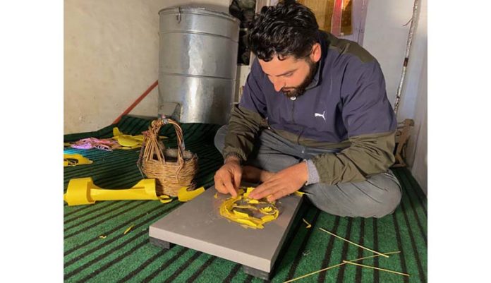 Suhail Ahmad crafting a shadow portrait in his home in Magam village of South Kashmir's Anantnag district.