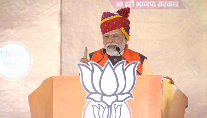 Prime Minister Narendra Modi addressing an election rally in support of BJP candidates for Rajasthan Assembly elections, in Sagwara on Wednesday. (UNI)