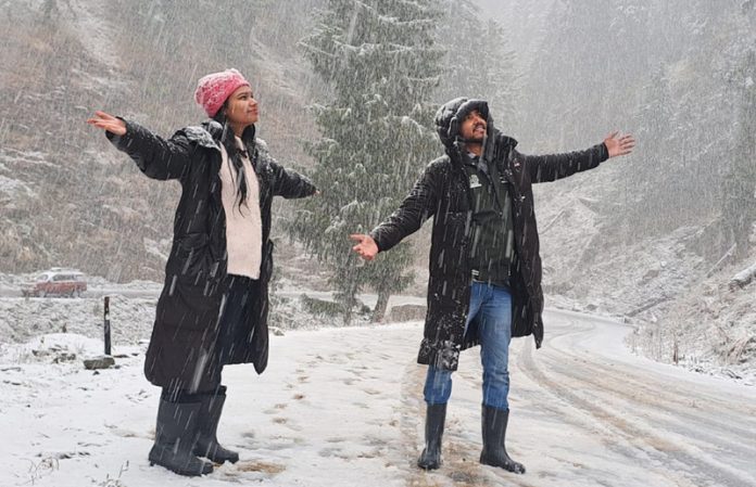 People enjoy snowfall in Bhaderwah on Friday. —Excelsior/Tilak Raj